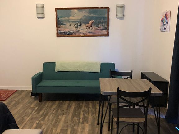 this unit is semi furnished with couch small table chairs dresser