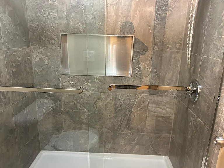 newly remodeled walk-in bath with sliding glass door