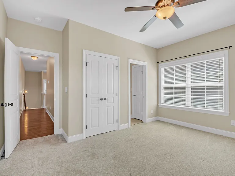 Third bedroom at the end of the hall includes a closet and ceiling fan