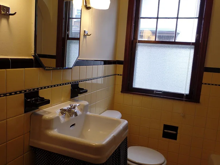 Original 1930s tile. Laundry shoot, shower and bath combo.