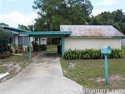 CORNER LOT-SIDE YARD. CARPORT W/ATTACHED WORKSHOP