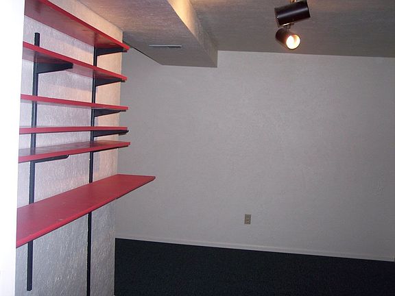 one of two basement bedrooms, with track lighting