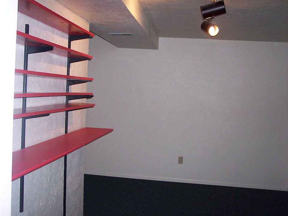 one of two basement bedrooms, with track lighting