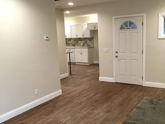 Living room to front door and kitchen. LVP flooring throughout most of home.