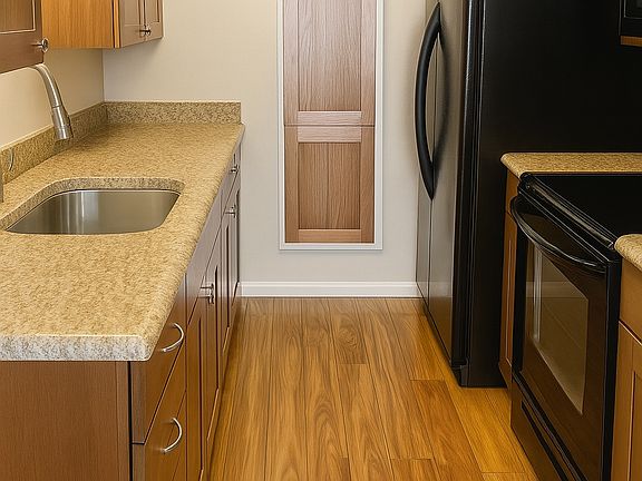 Kitchen with full-sized fridge/freezer, filtered water/ice maker, stove, microwave, garbage disposal and ample cabinet space