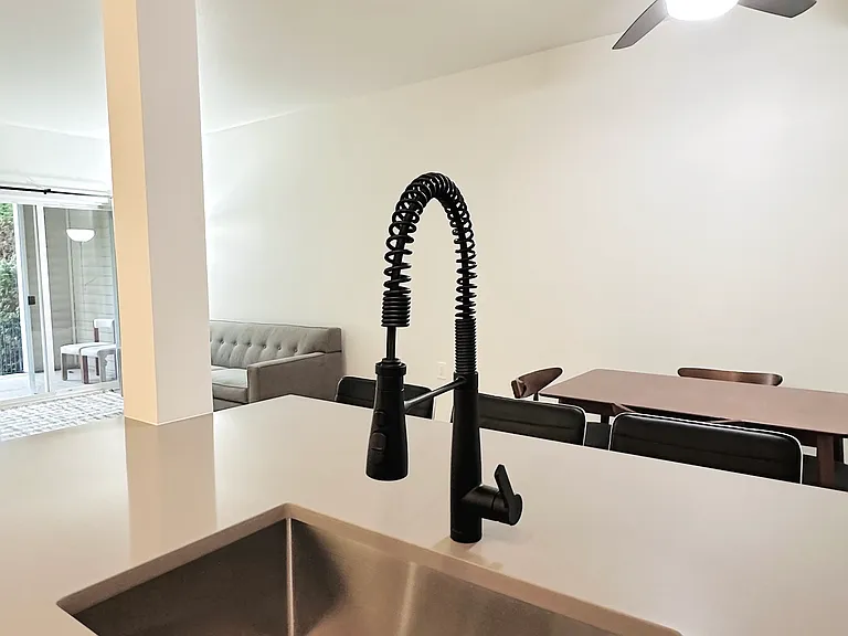 New, retractable kitchen faucet and large undermount sink.