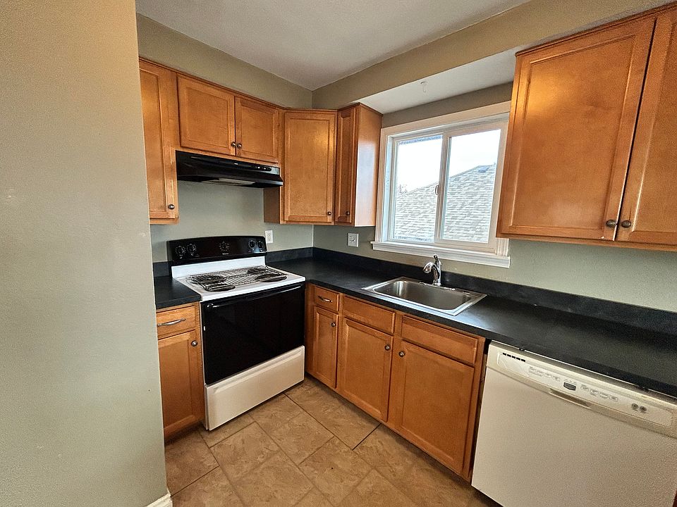 Newly renovated kitchen cabinets, sink, and counter