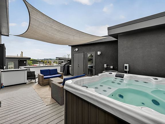 hot tub with view of the mountains and TV