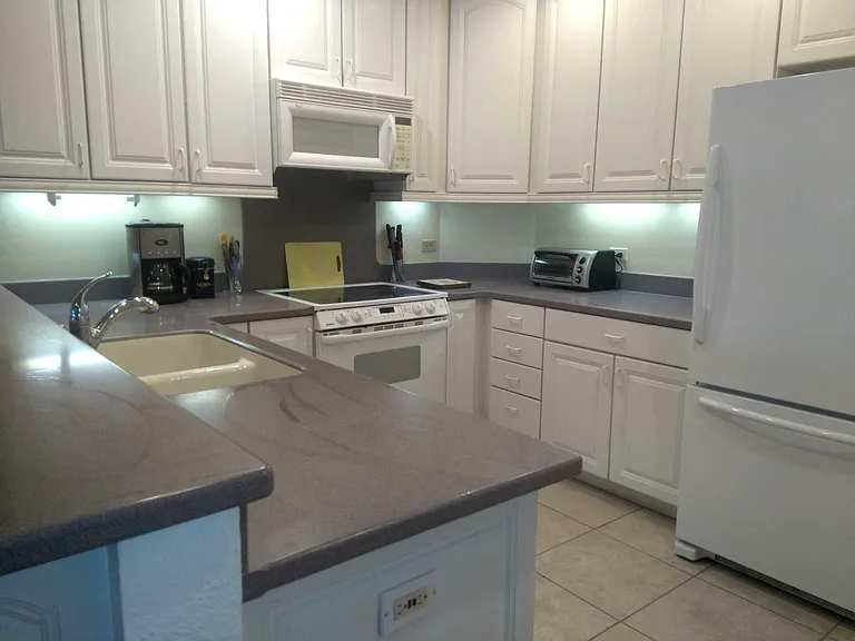 THE KITCHEN OFFERS A LOT OF CABINET STORAGE SPACE AND A WALK IN PANTRY/LAUNDRY