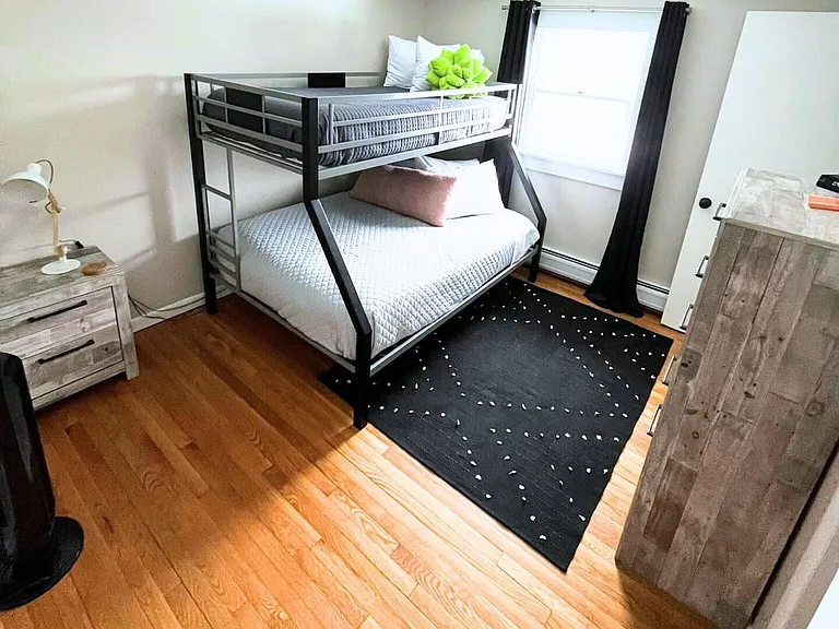 Main floor bedroom shown with bunk bed.
