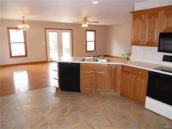 Kitchen with porcelain tile flooring is open to massive family room/dining area offering great entertaining space and bright natural lighting.