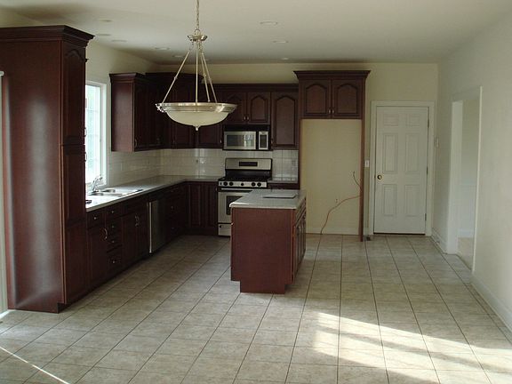 Cherry cabinets, ceramic floor, Corian tops