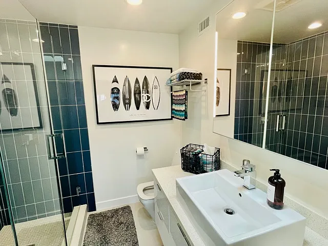 Primary bathroom with Large shower with frameless glass enclosure and glass tile