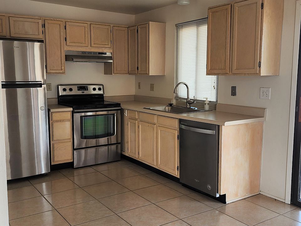 Stainless Steel Appliances and patio door to back yard with covered porch