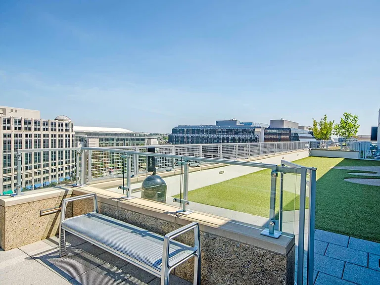 Relax, recharge, or let your pup roam_this rooftop green space is your personal urban oasis.