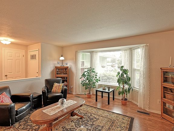 Entry and living room. Beautiful front garden can be seen from bay window.