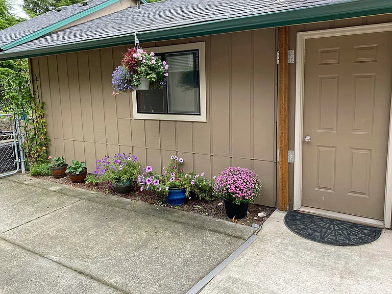 Door from outside - outdoor patio to left, parking on right