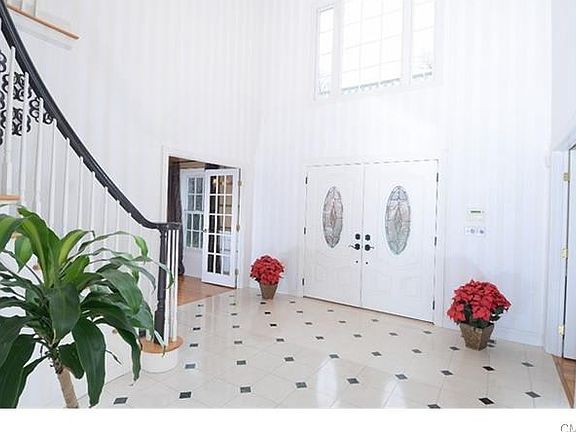 The 2-story marbled entry foyer is bright.