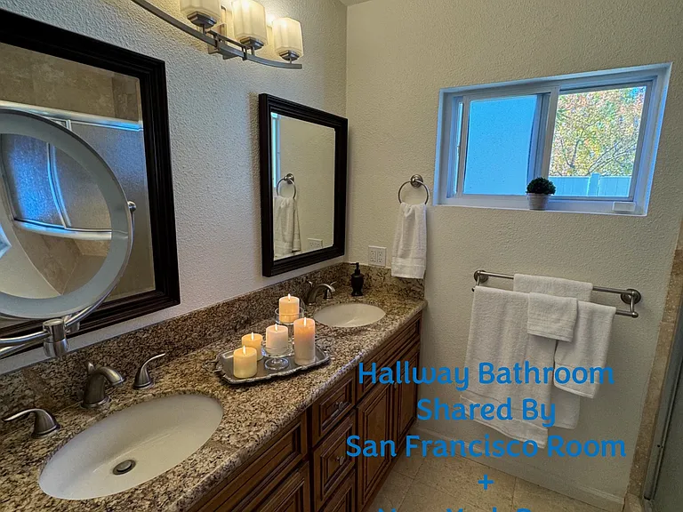 The dual sink and vanity hallway bathroom shared by rental Room 1 - San Francisco Room and rental Room 2 - New York Room