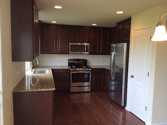 Cherry Spice Cabinets, Granite and SS Appliances