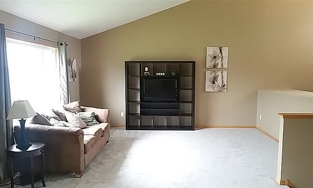 Living room with vaulted ceiling.