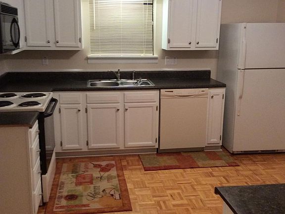 Spacious kitchen has a pantry and lots of cabinet storage.