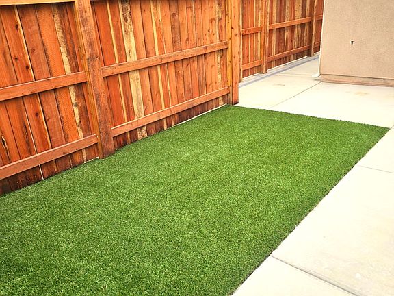 Private gated entrance with a modest yard for enjoying cooler nights on the patio.