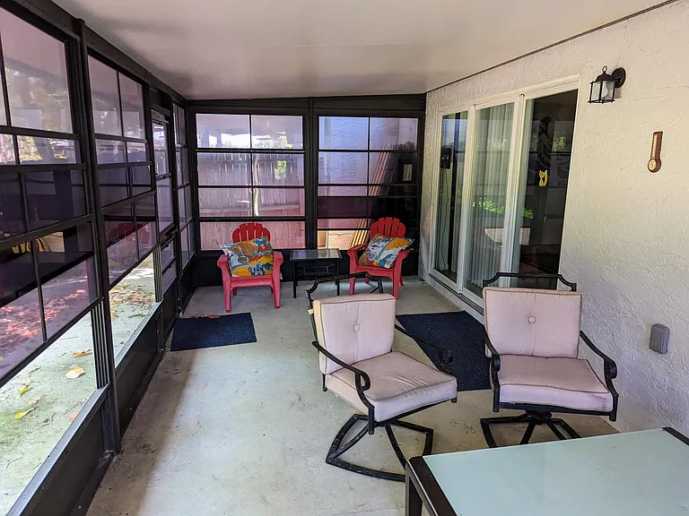 Lanai with screens and sliding panels. Slider to right enters into the living room
