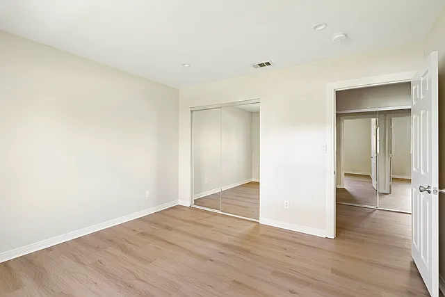 2nd bedroom with mirrored closet