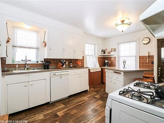Large kitchen with high ceilings. Lots of cabinets and counter space.
