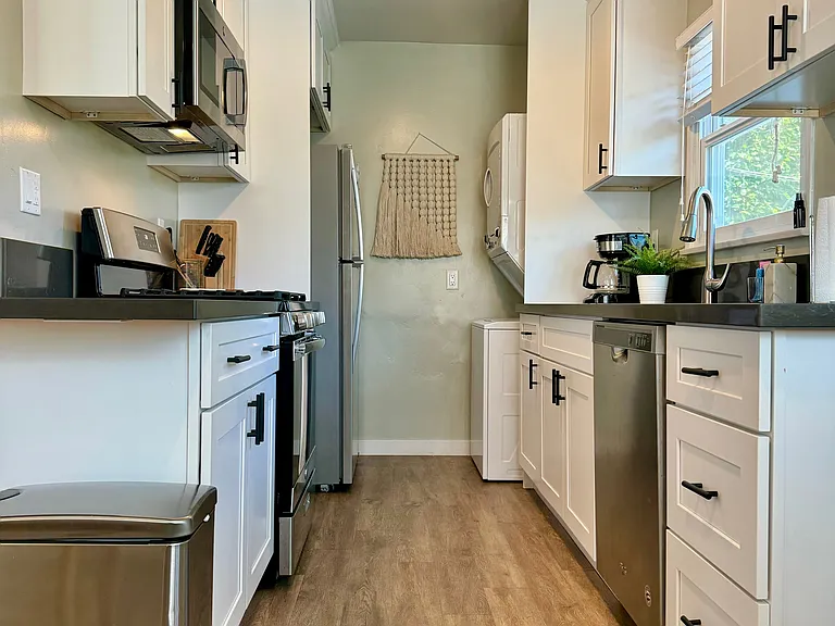 Full kitchen with gas stove and oven, washer/dryer, dishwasher, dining table for two, and everything else you would need