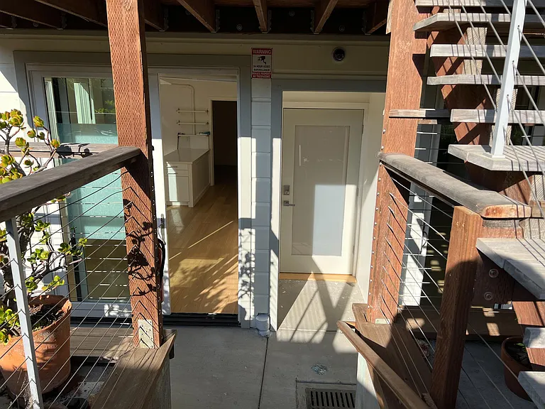 View form the sunny back yard into the apartment