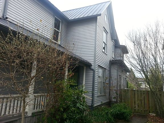 Front yard is fully fenced to keep critters in. Lovely native vegetation, front porch, ample parking.
