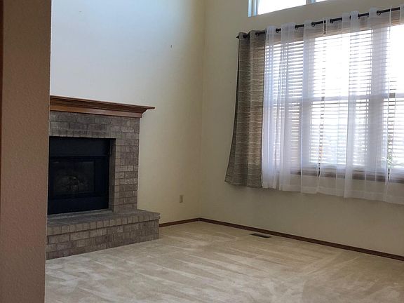 Main level living room with lots of natural light and gas fireplace
