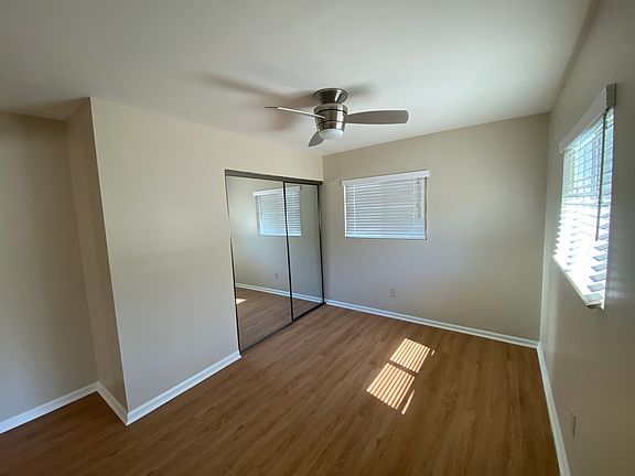 Primary bed with two windows large closet with sliding Mirrored doors / wall AC/ Heater / ceiling fan