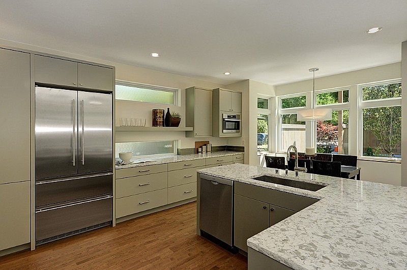Custom painted cabinetry, stone counters, glass tile backsplash.