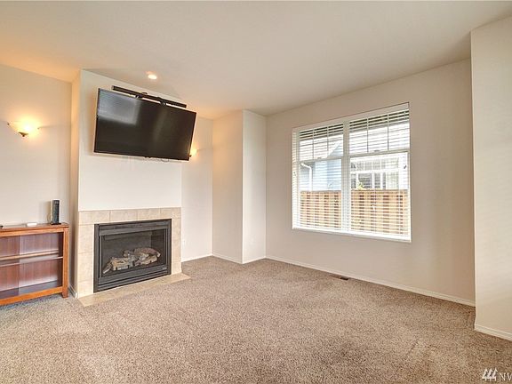 Enjoy the cozy fireplace in the living room.