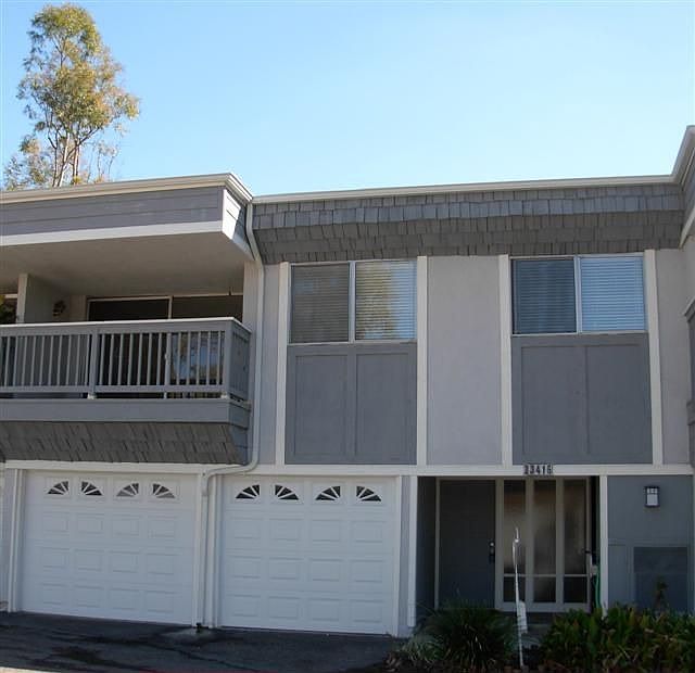 Front of home with balcony.