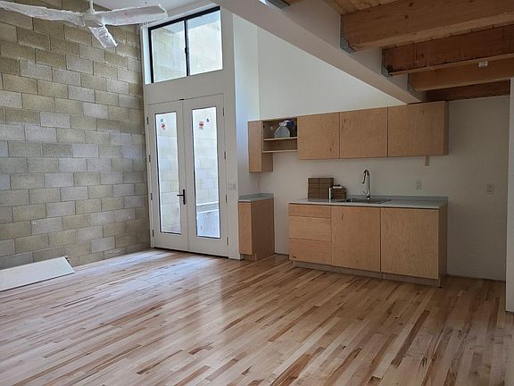 Unit A: hardwood floors, exposed brick wall, 14ft ceiling. Stove and fridge have been added :)