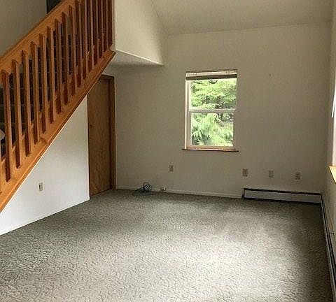 Living room with stairs to loft bedroom