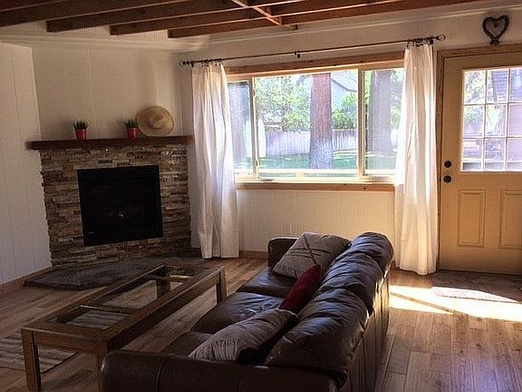 Gas fireplace and leather sofa in living room downstairs