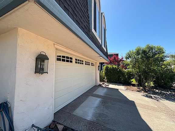 Standing at the entrance and looking towards the driveway and 2-car garage