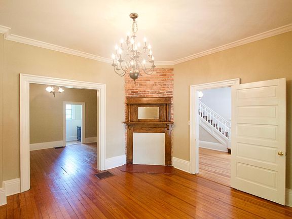 Living Room Looking into Dining room and Foyer/ Entrance and Stairs