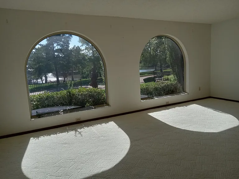 Serene view of lake from living room. New pics will show new wood look flooring.