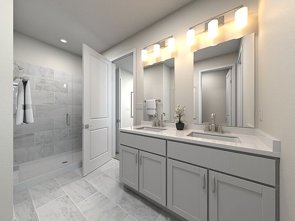 The primary bathroom offers dual vanity sinks and a walk-in closet.
