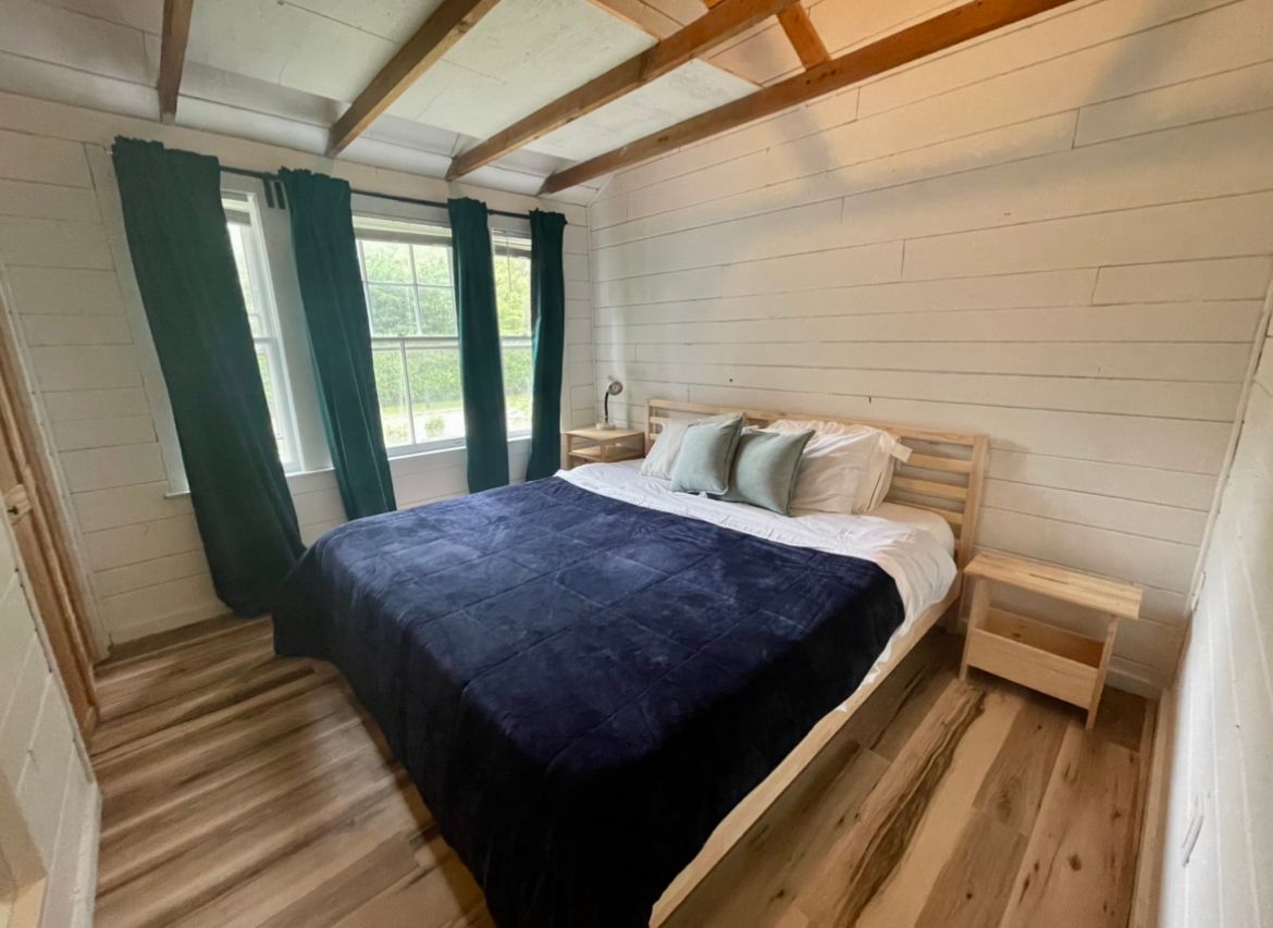  Gut renovated bedroom with lofted ceiling, coat closet, king sized, bed and two night stands + AC