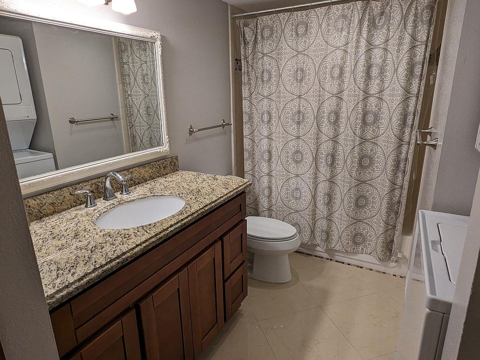 Spacious bathroom with updated vanity and granite top