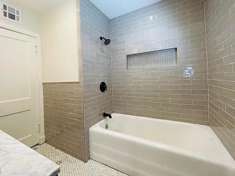 Shower/cast iron bath tub -- Tub refinished after photo taken