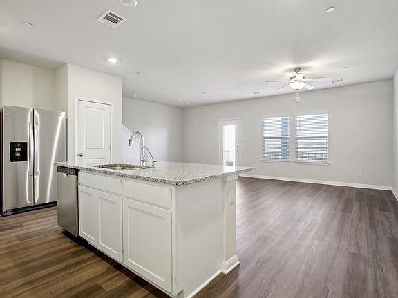 The open concept kitchen, living, and dining areas are great for entertaining.
