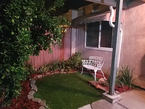 White bench to relax under awning, a night time view